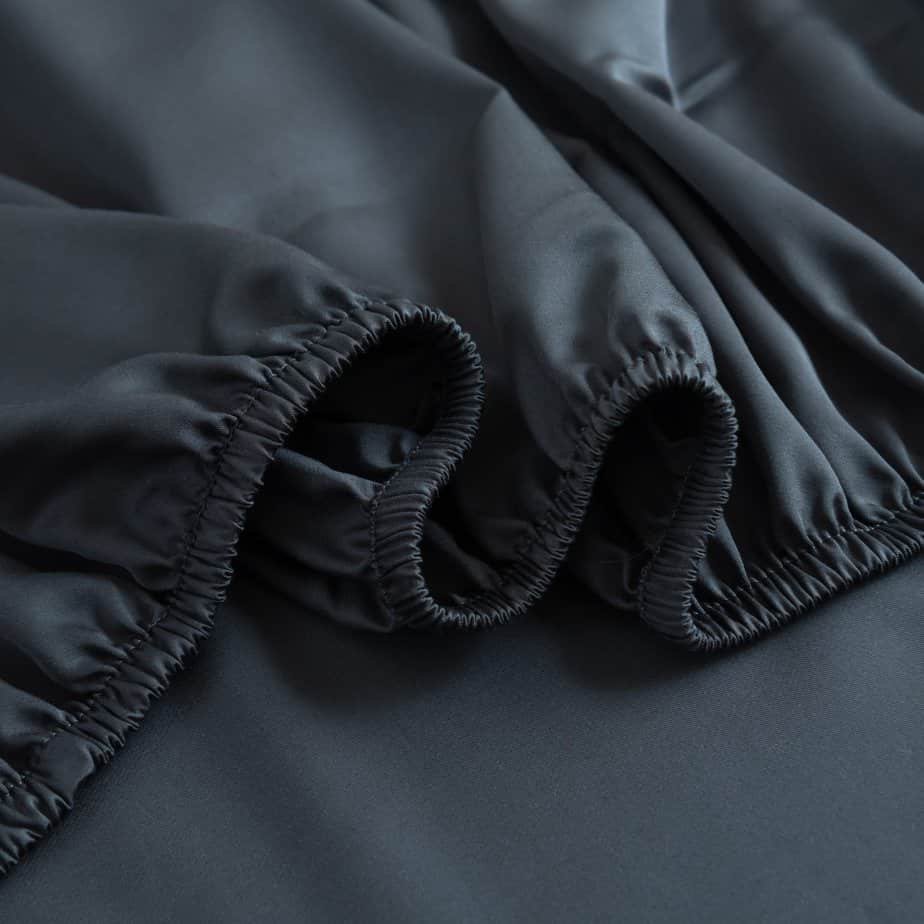 Space Blue bamboo fitted sheet showing its soft, gathered elastic edge