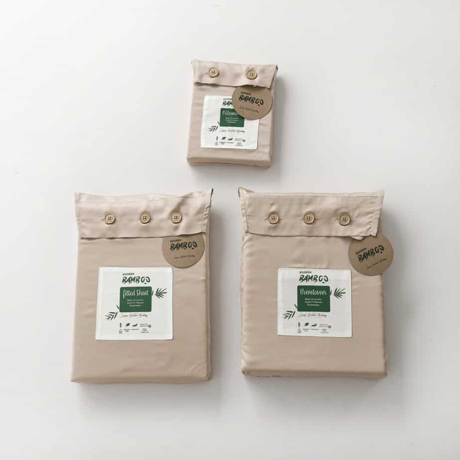 Folded Soft Taupe bamboo pillowcase, fitted sheet, and duvet cover packages side by side, each with bamboo buttons and the Boomba Bamboo branded label