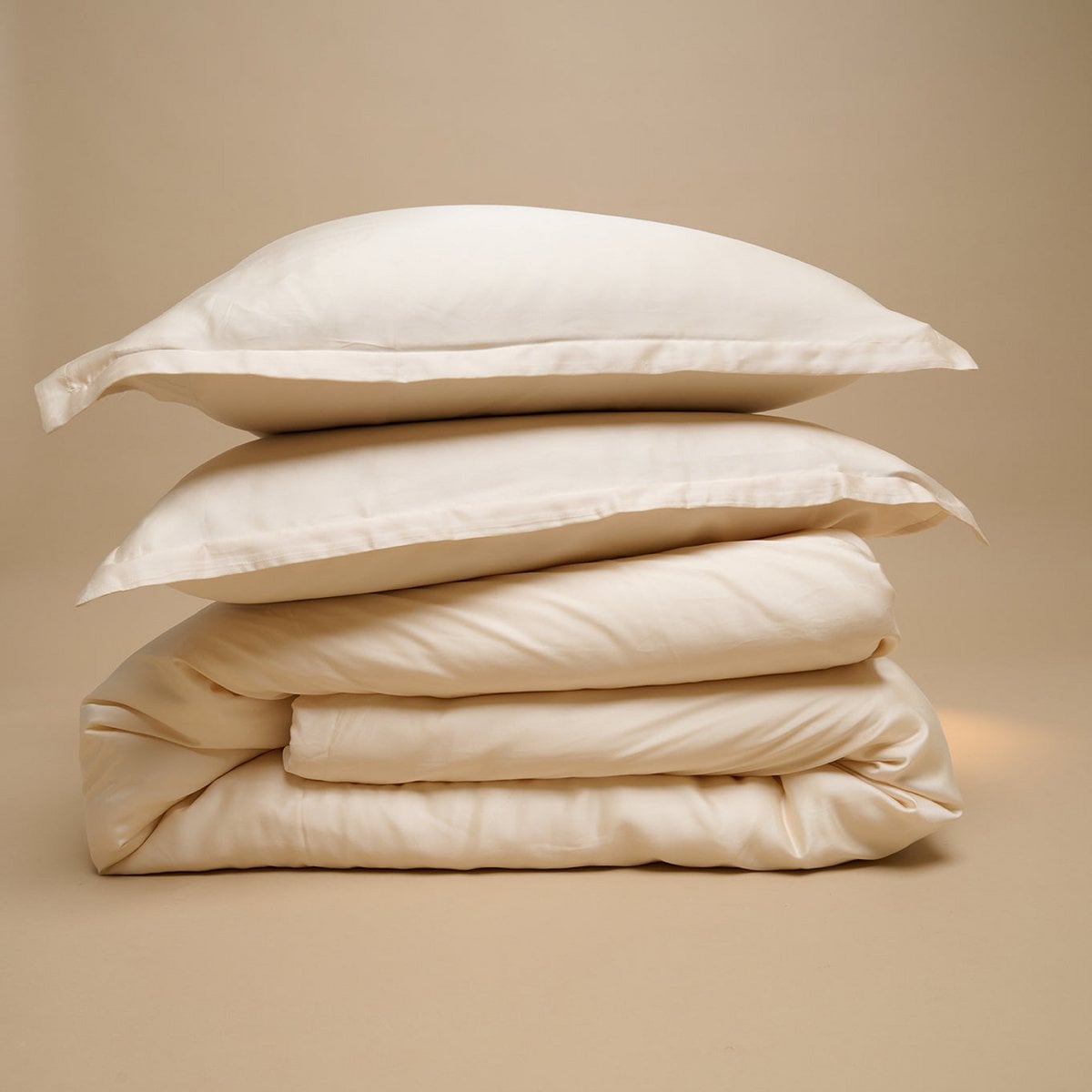 Tencel™ Sateen Duvet Cover and pillows in White Sand, folded