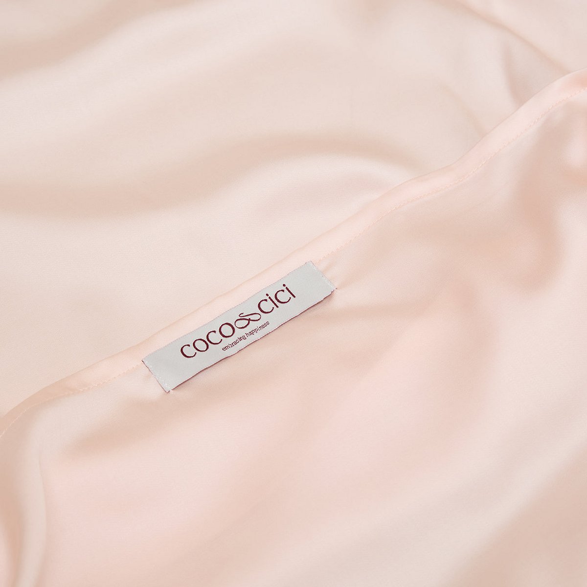 Close-up of the Coco & Cici brand label on the Tencel™ Sateen Pillowcase in Peach White
