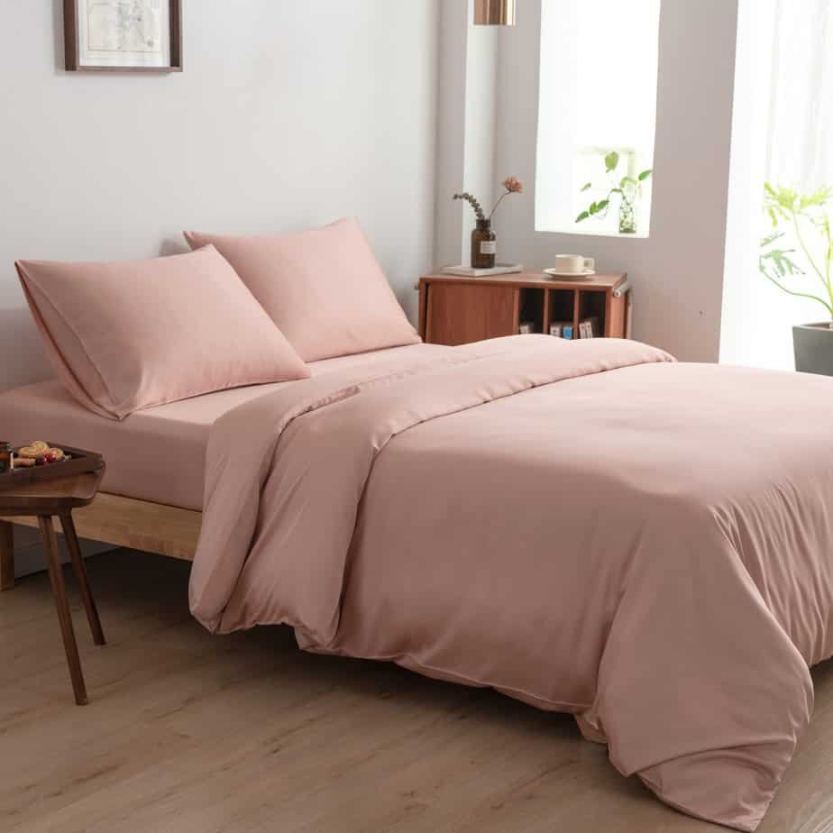 Cuddle Pink bamboo bedding set on a made bed