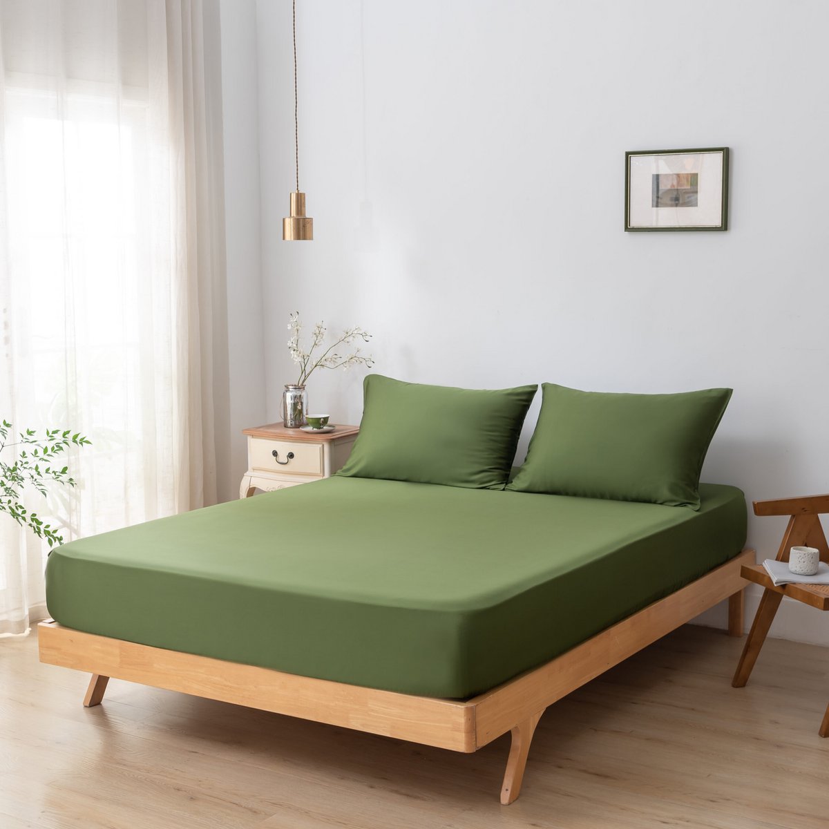 Deep Moss bamboo bedding set on a fully made bed