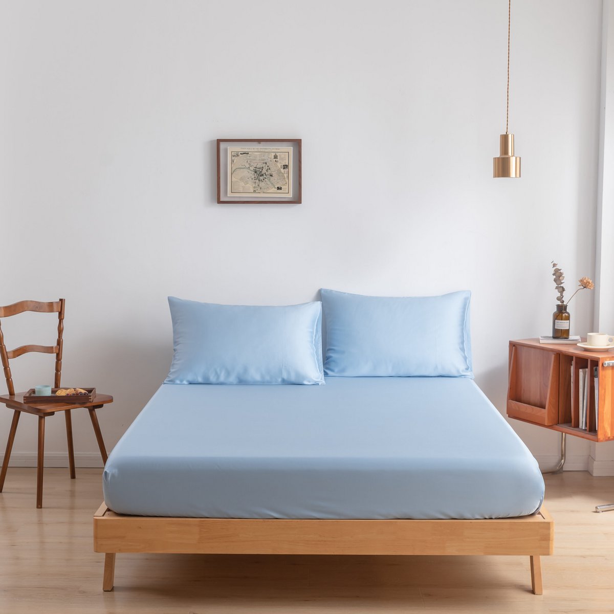 Sky Blue bamboo bedding set on a bed by a window
