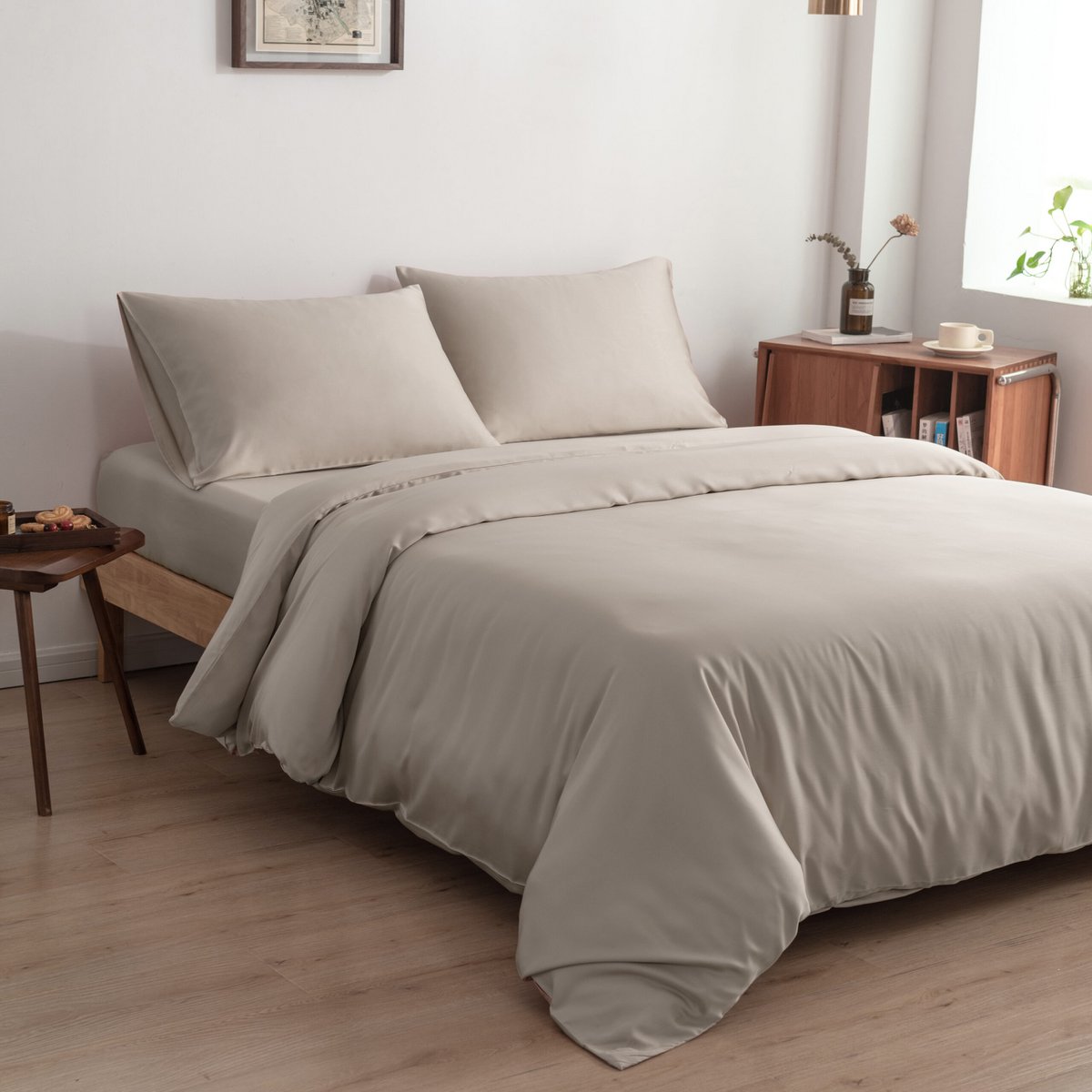 Bamboo duvet cover in Soft Taupe on a bed with a framed map on the wall and a wooden nightstand