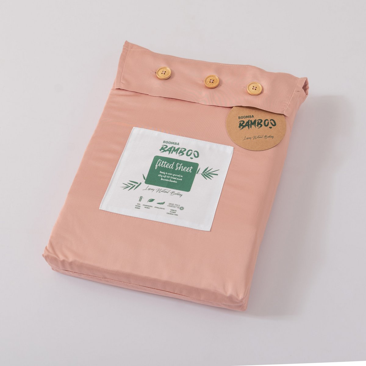 Cuddle Pink bamboo fitted sheet folded and packaged with the Boomba Bamboo product label.