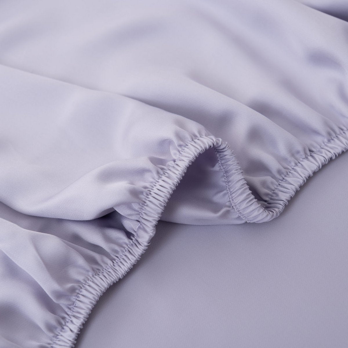 Close-up of the Lavender Mist bamboo fitted sheet's folded elastic corner.