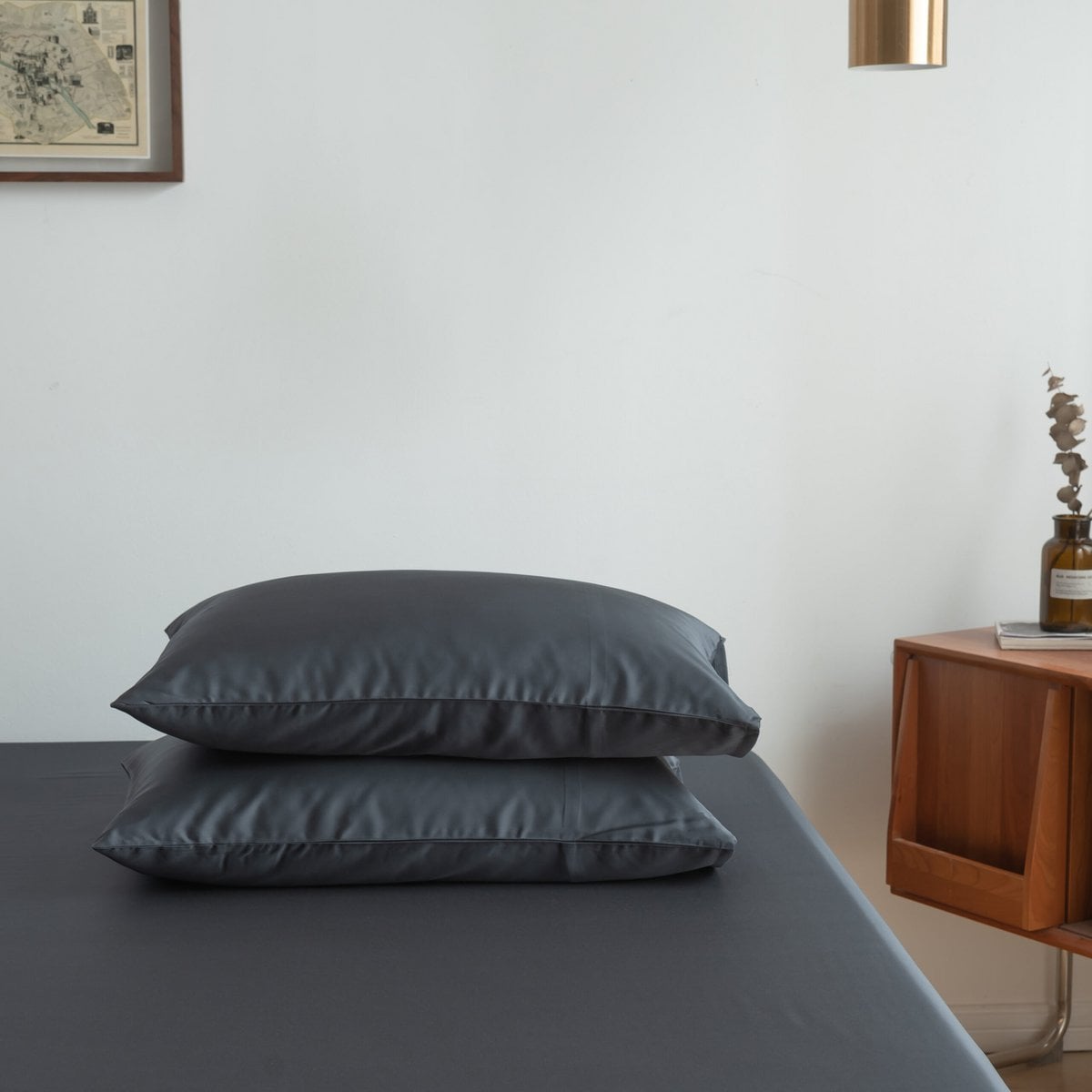 Space Blue bamboo pillowcases styled with a nightstand
