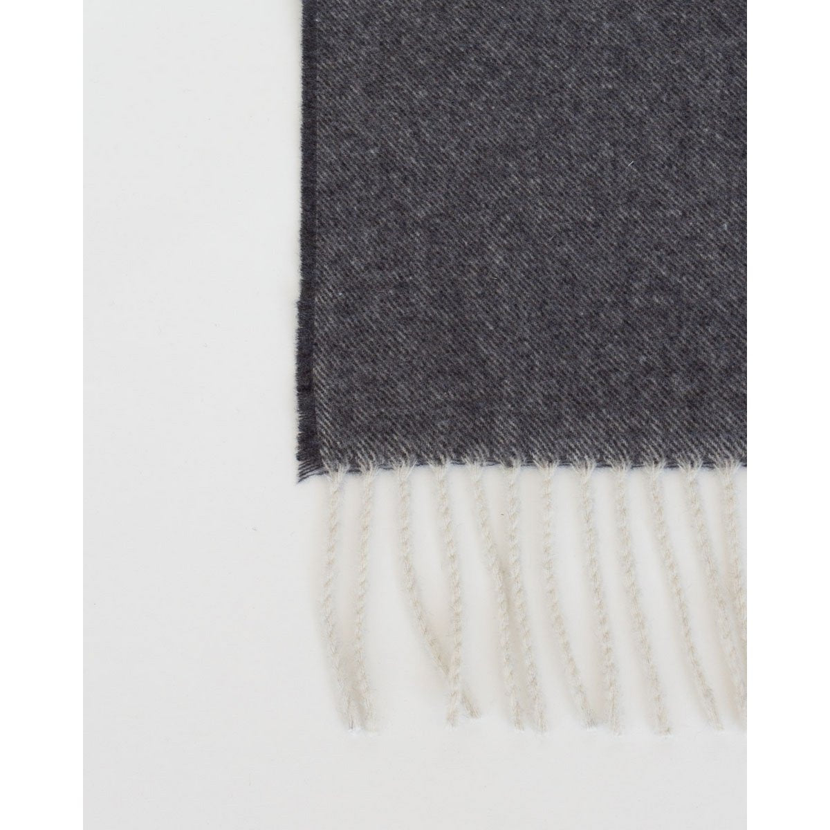 Close-up of Tibet throw's soft cashmere-wool texture in dark grey