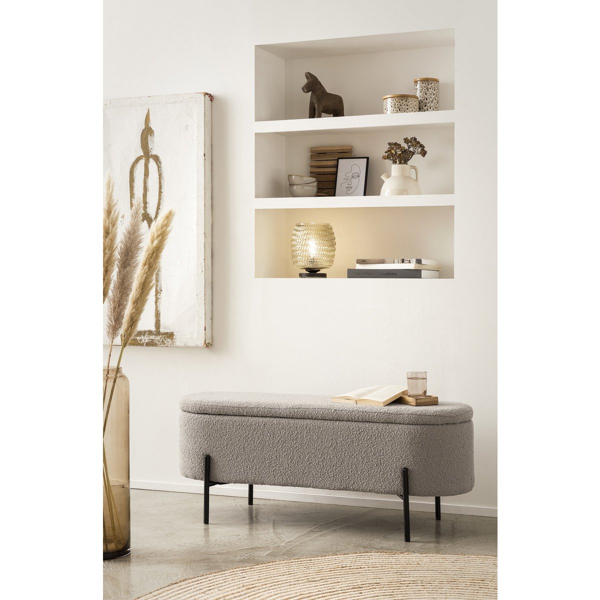 Taupe bouclé storage bed bench with the lid closed, styled in front of a shelf alcove