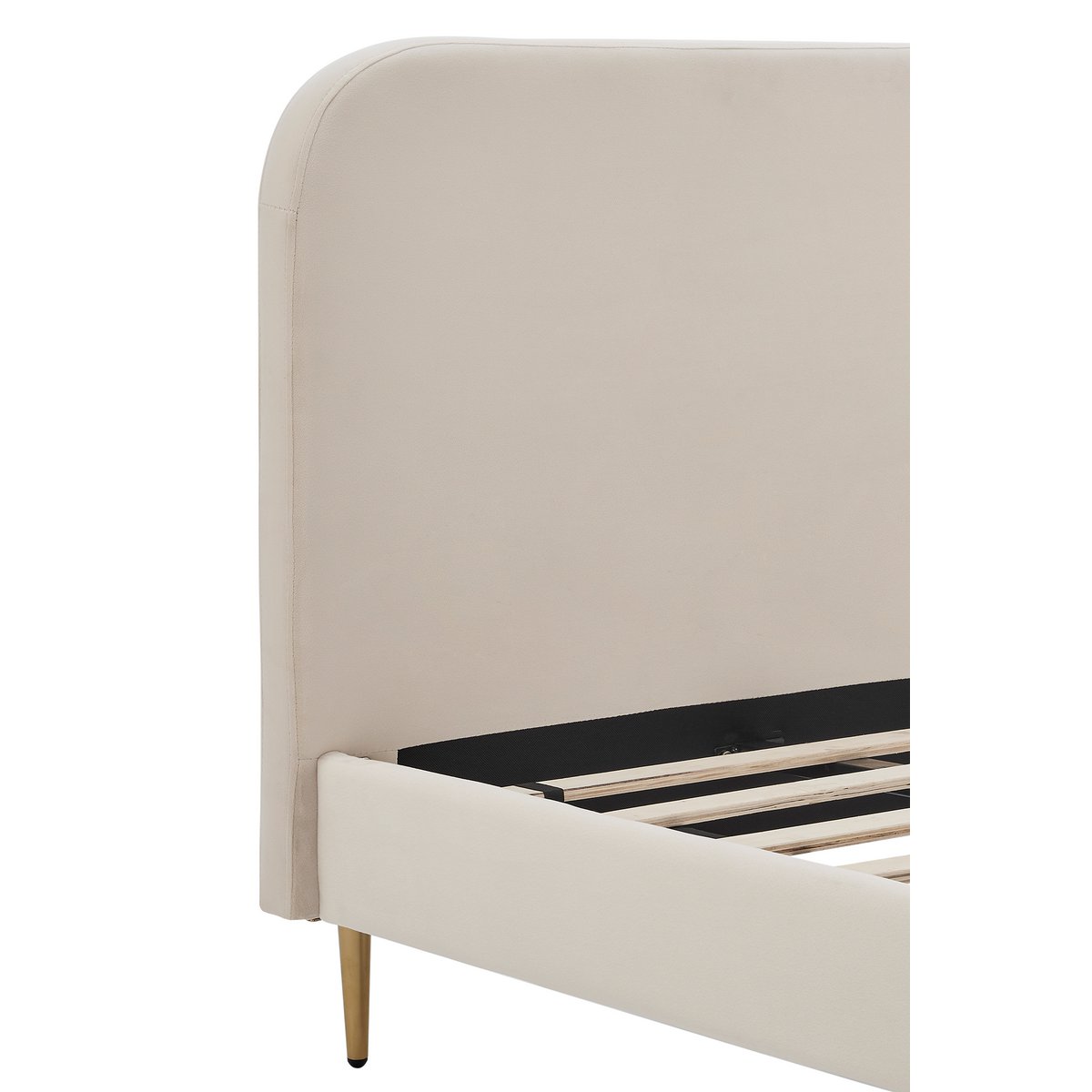 Close-up of the rounded beige velvet headboard and a gold-painted foot