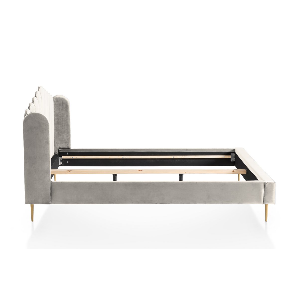 Side view of the beige velvet shell bed showing the headboard profile and gold-painted feet